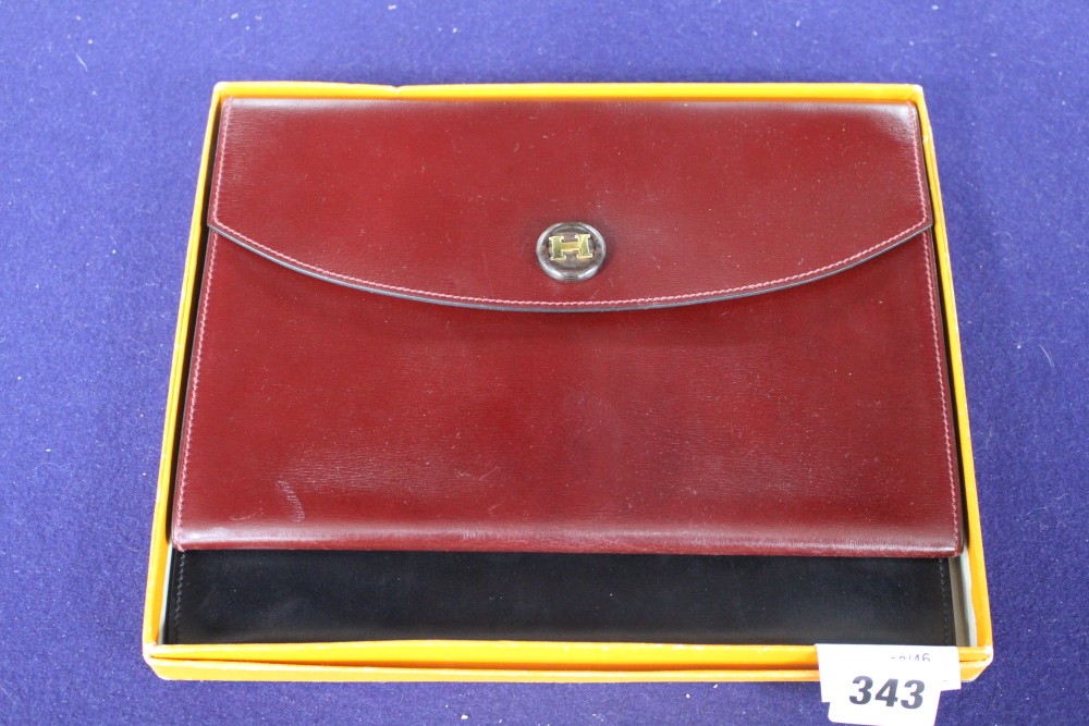 Two Hermes leather clutch purses, one in black, the other burgundy, 24 x 16.5cm, with one Hermes orange card box